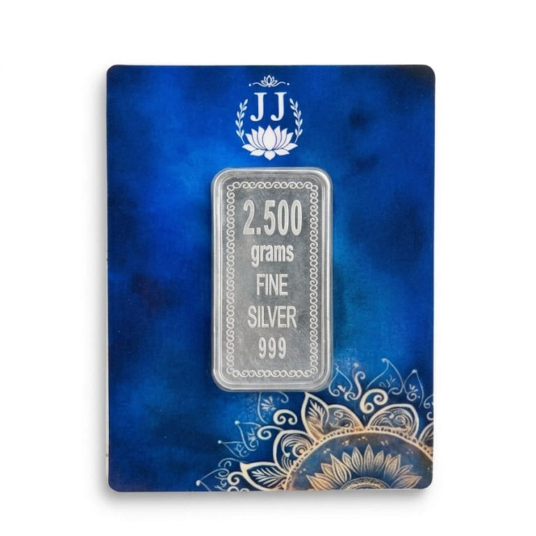 A 2,500 grams fine silver 999 silver bar displayed on a textured blue presentation card with gold mandala designs and a 'JJ' brand logo.