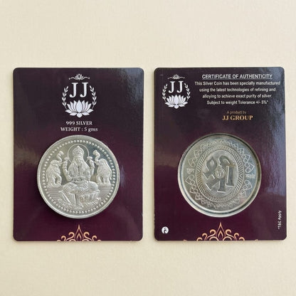 A silver coin displayed on two dark purple backing cards against a light beige background. The left card shows the coin with 'JJ GROUP' branding and '1999 SILVER WEIGHT 2.