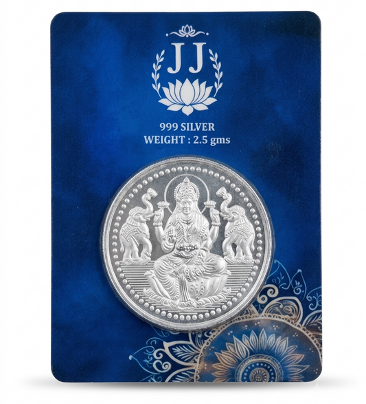 A 999 silver coin of Lord Ganesha displayed on a dark blue textured backing card. The card features a white 'JJ' lotus logo and text indicating '999 SILVER' and 'WEIGHT 2.